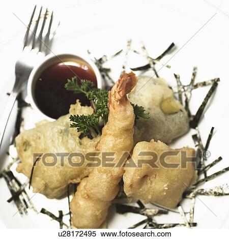 Stock Photography - Close-up of a seafood with a ketchup and a fork in a plate. Fotosearch