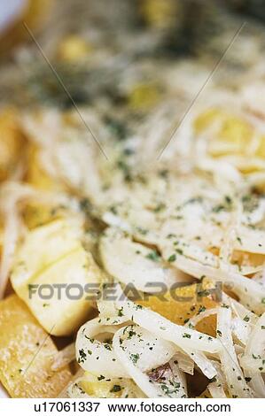 Stock Photo - Close-up of chicken garnished with onions. Fotosearch