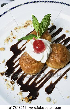 Stock Photograph - High angle view of cookies topped with whipped cream. Fotosearch