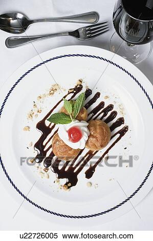 Stock Photography - High angle view of cookies topped with whipped cream. Fotosearch