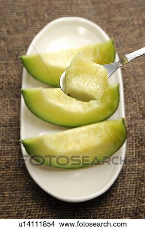 Picture - Cut Muskmelon. Fotosearch