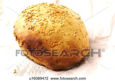 Stock Image - Close-up of a fried dumpling topped with sesame seeds. Fotosearch