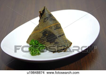 Picture - Close-up of bamboo leaf wrapped Zongzi. Fotosearch