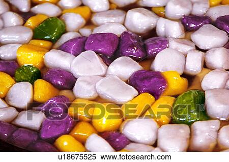 Stock Photography - Close-up of multi colored sweet potato in gravy. Fotosearch