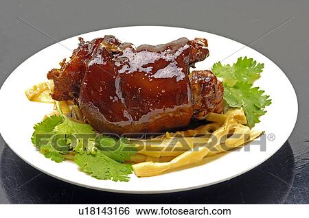 Stock Photograph - Close-up of Oriental pork trotter with bamboo shoot. Fotosearch
