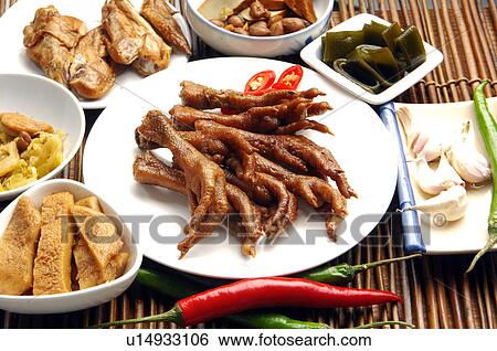 Stock Photograph - High angle view of fried chicken feet served with chicken wings and accompaniments. Fotosearch