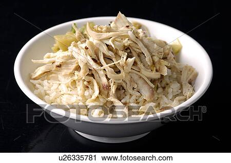 Stock Image - High angle view of Oriental shredded chicken and rice. Fotosearch