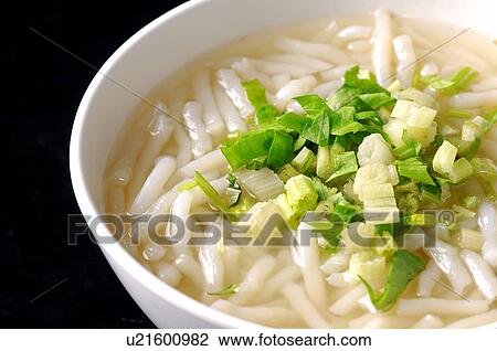 Stock Image - High angle view of rice-flour noodle soup garnished with leeks. Fotosearch