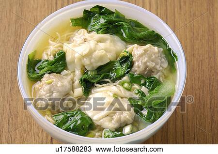 Stock Image - High angle view of wonton pak choi soup. Fotosearch