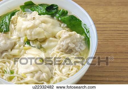 Stock Image - High angle view of wonton pak choi soup. Fotosearch