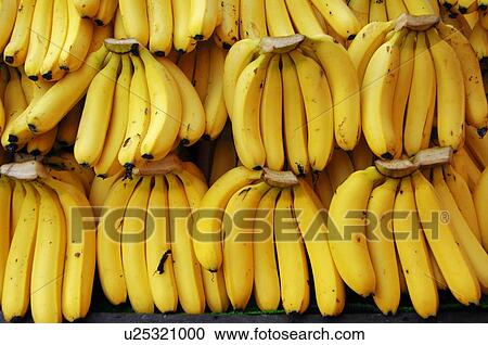 Stock Image - Close-up of bunch of yellow bananas. Fotosearch