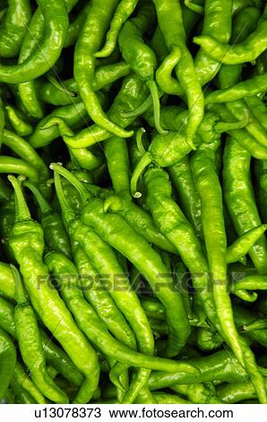 Stock Image - Close-up of green chili peppers. Fotosearch