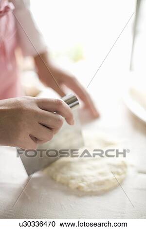 Human hand of young woman cutting dough View Large Photo Image Stock Image - Human hand of young woman cutting dough. Fotosearch