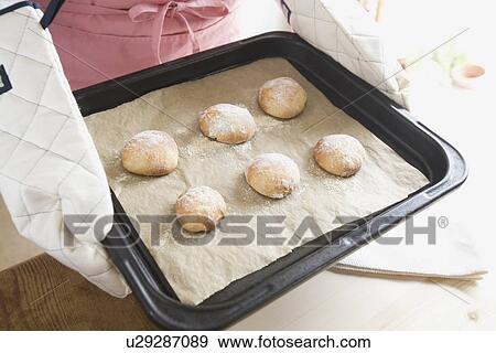 Human hand of young woman holding fresh baked bread View Large Photo Image Stock Photo - Human hand of young woman holding fresh baked bread. Fotosearch