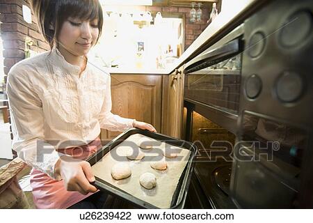 Young woman baking bread View Large Photo Image Stock Image - Young woman baking bread. Fotosearch