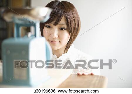 Stock Photograph - Young woman checking scale. Fotosearch