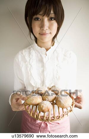 Young woman holding bread fresh from oven View Large Photo Image Stock Image - Young woman holding bread fresh from oven. Fotosearch