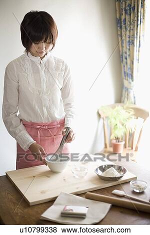 Young woman making bread View Large Photo Image Stock Photo - Young woman making bread. Fotosearch