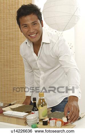 Stock Photograph - Asian man is making sushi. Fotosearch