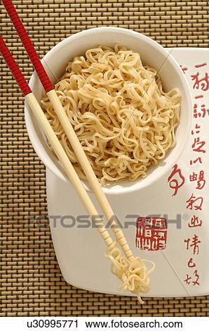Stock Image - Asian noodles in a bowl with chopsticks. Fotosearch