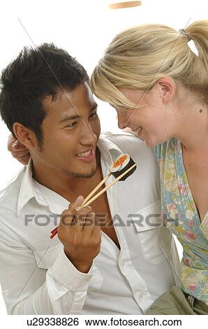 Couple is eating sushi View Large Photo Image Stock Photograph - Couple is eating sushi. Fotosearch
