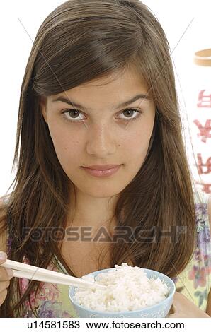 Woman is eating rice with chopsticks View Large Photo Image Stock Image - Woman is eating rice with chopsticks. Fotosearch