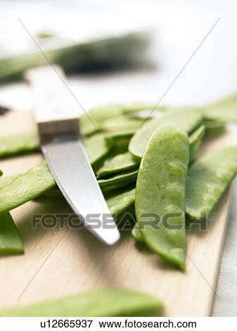 Cutting mange touts on a wooden board View Large Photo Image Stock Photo - Cutting mange touts on a wooden board. Fotosearch