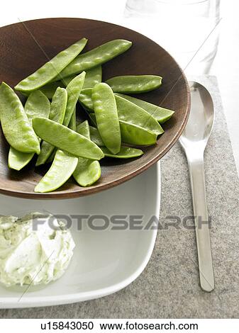 Stock Image - Mange tout with dip. Fotosearch