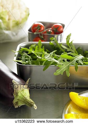 Stock Image - Ruccola, augergine, tomatoes and yellow paprika. Fotosearch