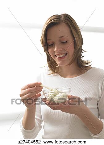 Woman dipping kohlrabi View Large Photo Image Stock Image - Woman dipping kohlrabi. Fotosearch