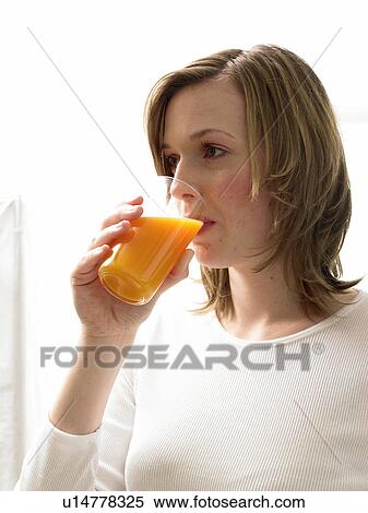 Stock Photography - Woman drinking juice. Fotosearch