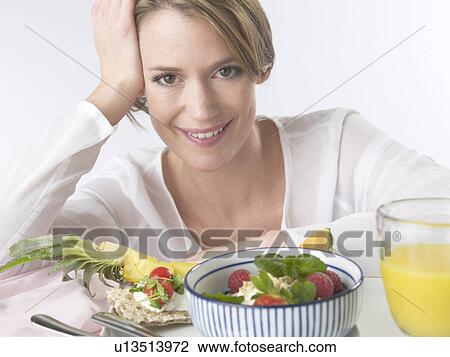Woman is having breakfast with crispbread and cereals View Large Photo Image Stock Image - Woman is having breakfast with crispbread and cereals. Fotosearch
