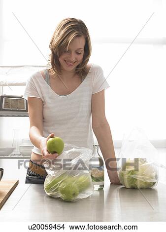 Woman with apples in the kitchen View Large Photo Image Picture - Woman with apples in the kitchen. Fotosearch