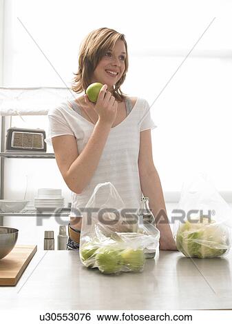 Woman with apples in the kitchen View Large Photo Image Stock Photograph - Woman with apples in the kitchen. Fotosearch