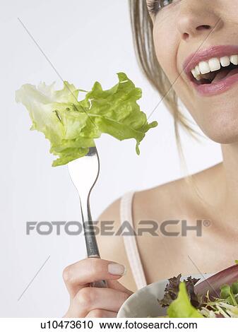 Stock Image - Woman with salat and fork. Fotosearch