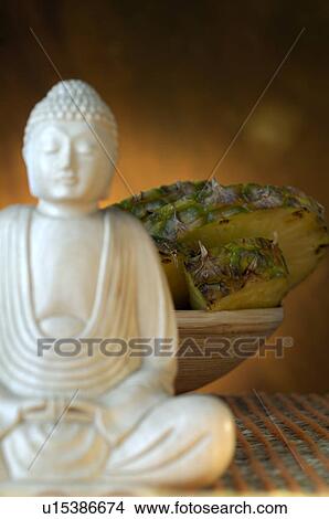 Picture - Pineapple and Buddha. Fotosearch