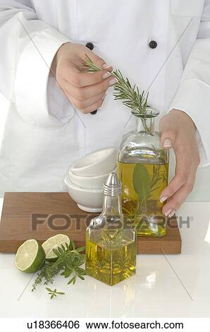 Stock Photograph - herbage oil with rosemary. Fotosearch