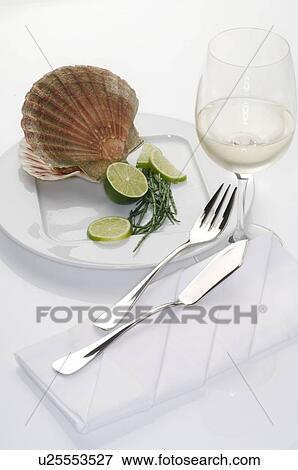 Stock Photo - Scallop on a plate with a glass of white wine. Fotosearch
