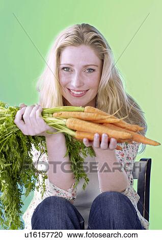 Blonde woman with carrots View Large Photo Image Stock Image - Blonde woman with carrots. Fotosearch