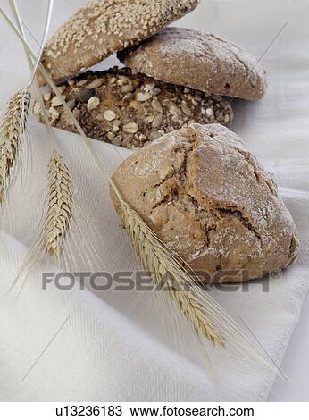 Stock Image - Organic bread rolls and rye ears. Fotosearch