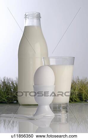 Organic milk in bottles and egg cup View Large Photo Image Stock Image - Organic milk in bottles and egg cup. Fotosearch