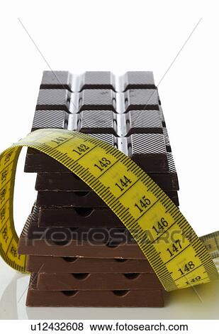 Chocolate and tape measure View Large Photo Image Stock Photo - Chocolate and tape measure. Fotosearch