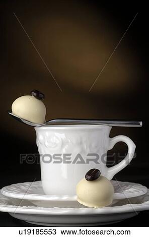 Stock Image - Cup and two pieces of chocolate. Fotosearch