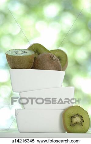 Stock Photography - Kiwi fruits in a stack of white bowls. Fotosearch