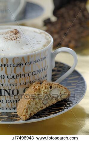 Stock Image - Cappuccino and almond cookie. Fotosearch