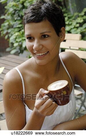 Stock Photo - Dark haired woman with cappuccino cup. Fotosearch