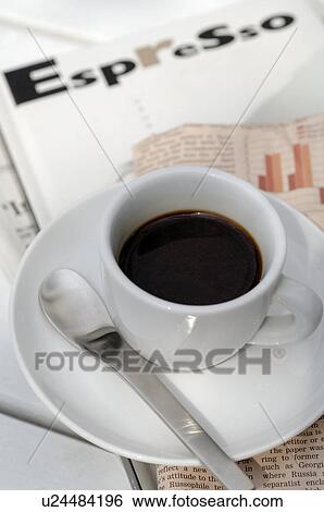 Stock Photograph - Espresso cup on newspaper. Fotosearch