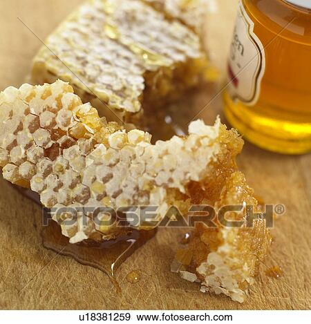 Stock Photo - Honeycomb and jar of honey. Fotosearch