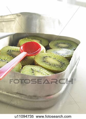 Stock Photography - Kiwi in half in lunch box. Fotosearch