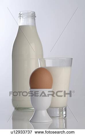 Stock Photo - Natural milk in a bottle and biological egg in an eggcup. Fotosearch